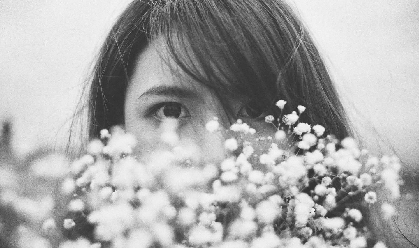 girl behind flowers
